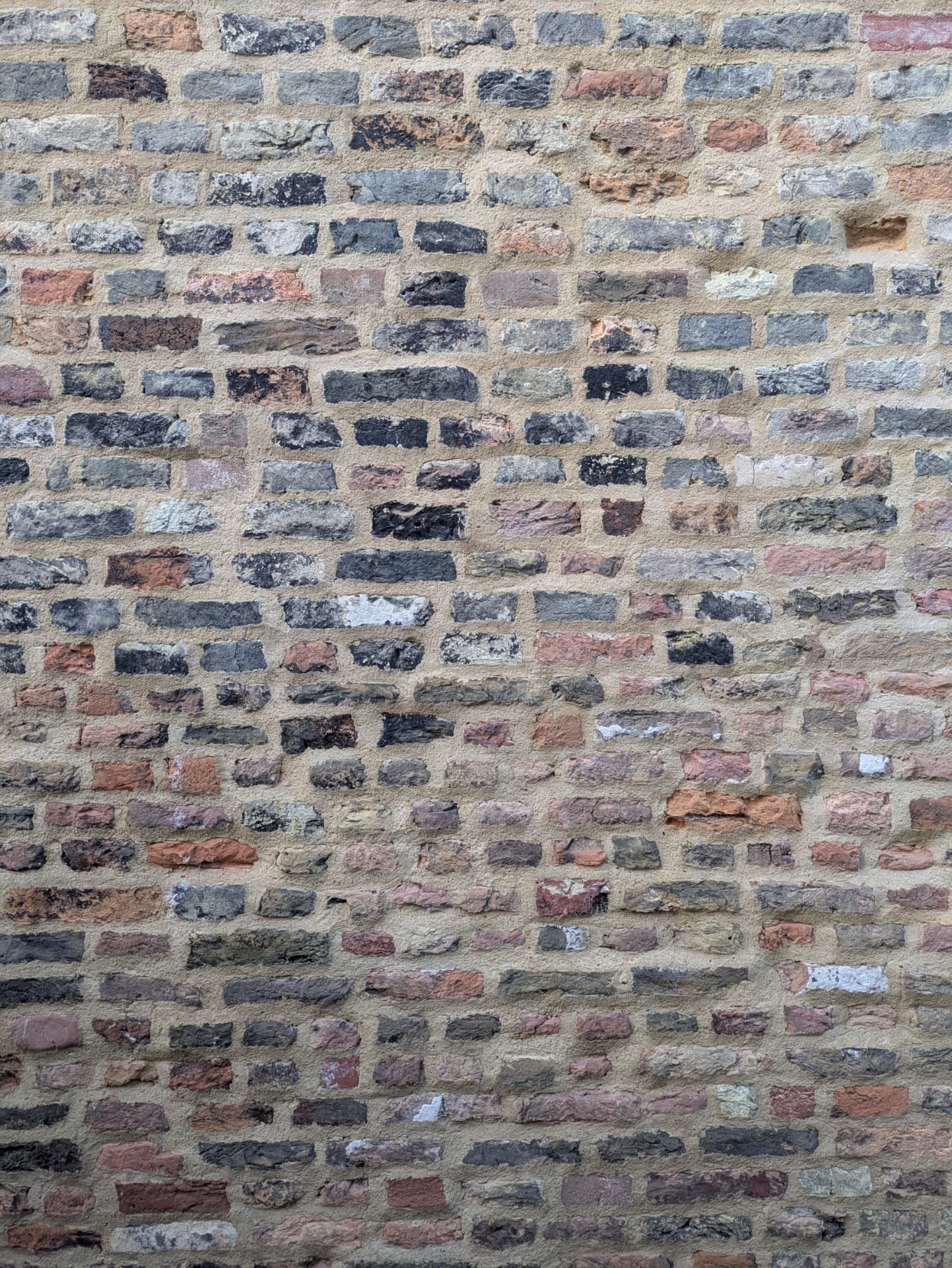 Weathered brick wall repointed in lime mortar