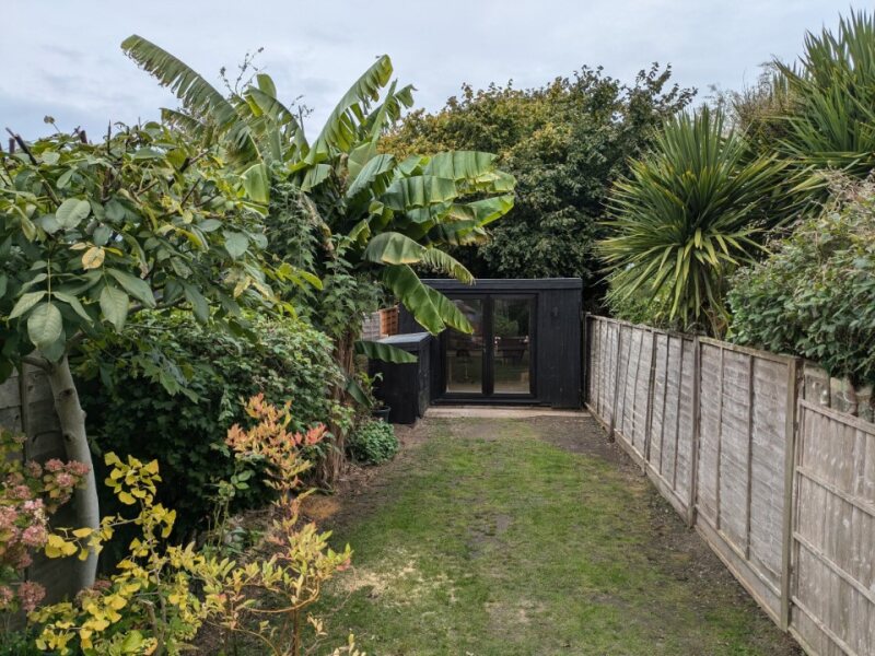 Garden with black outbuilding